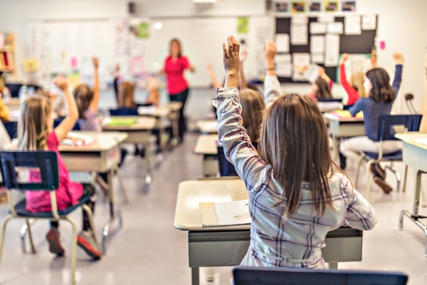 Girl raising her hand in a classroom
